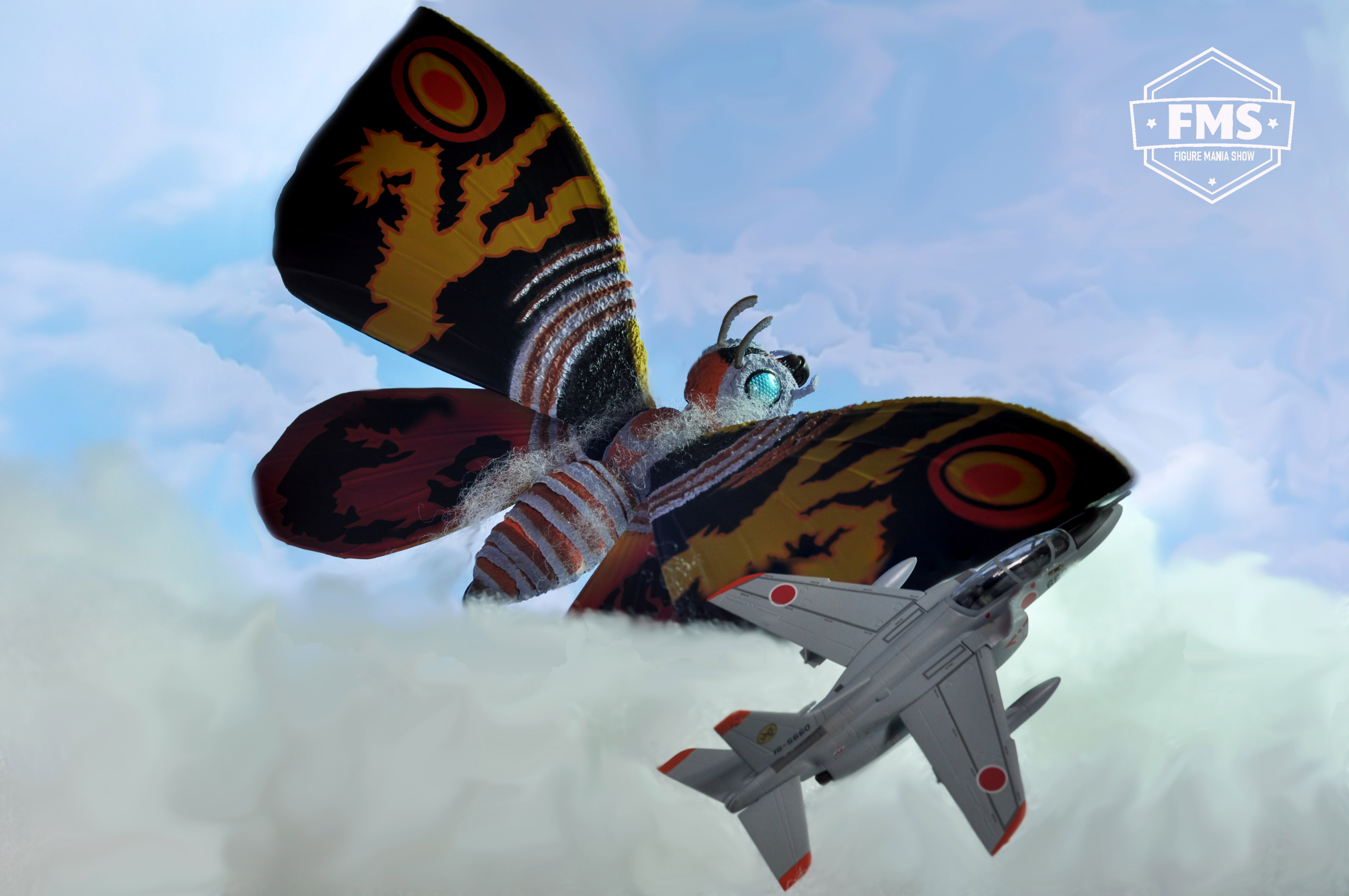 Mothra flying above the clouds.